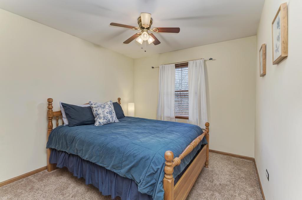 460 Springwood Lane Bolingbrook, IL 60440 - Photo 26 of 35 a bed room with a bed and a ceiling fan
