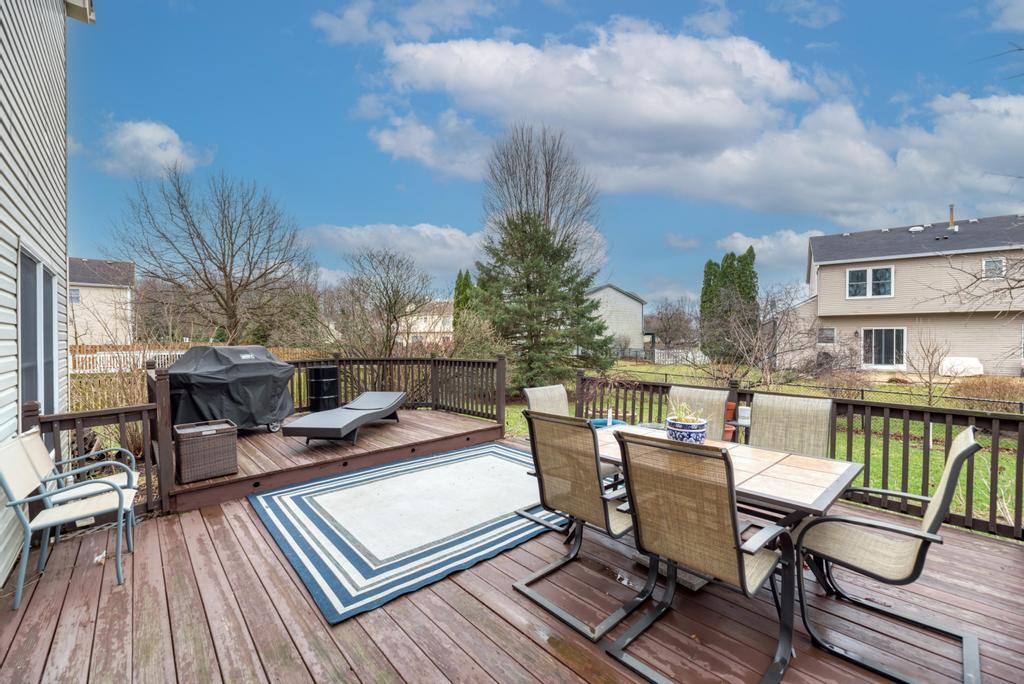 460 Springwood Lane Bolingbrook, IL 60440 - Photo 32 of 35 a view of a roof deck with table and chairs couches with wooden floor