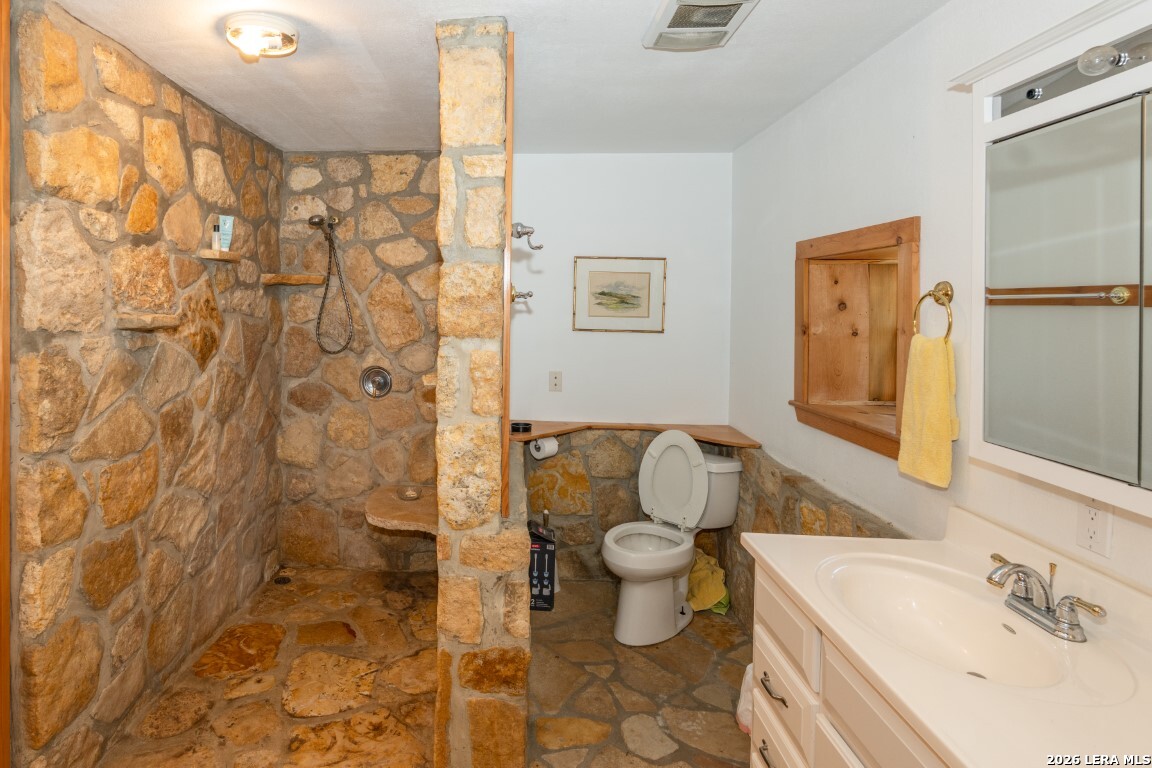 3655 North Seco Creek Road Medina, TX 78055 - Photo 20 of 45 a bathroom with a sink toilet and shower