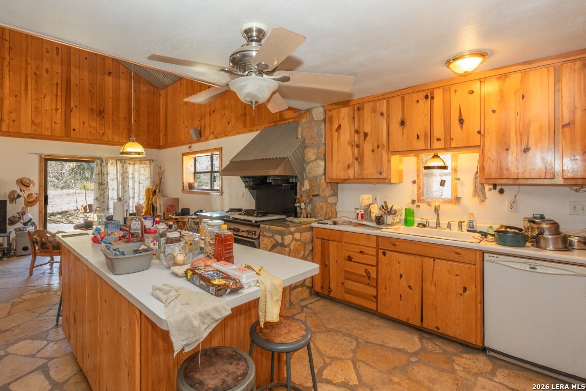 3655 North Seco Creek Road Medina, TX 78055 - Photo 27 of 45 a kitchen with a sink a stove and chairs