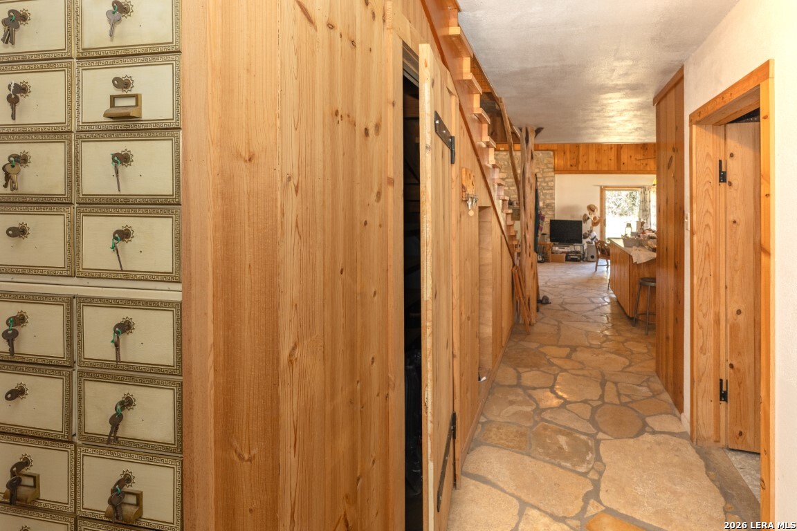 3655 North Seco Creek Road Medina, TX 78055 - Photo 30 of 45 a view of a hallway with wooden shelves