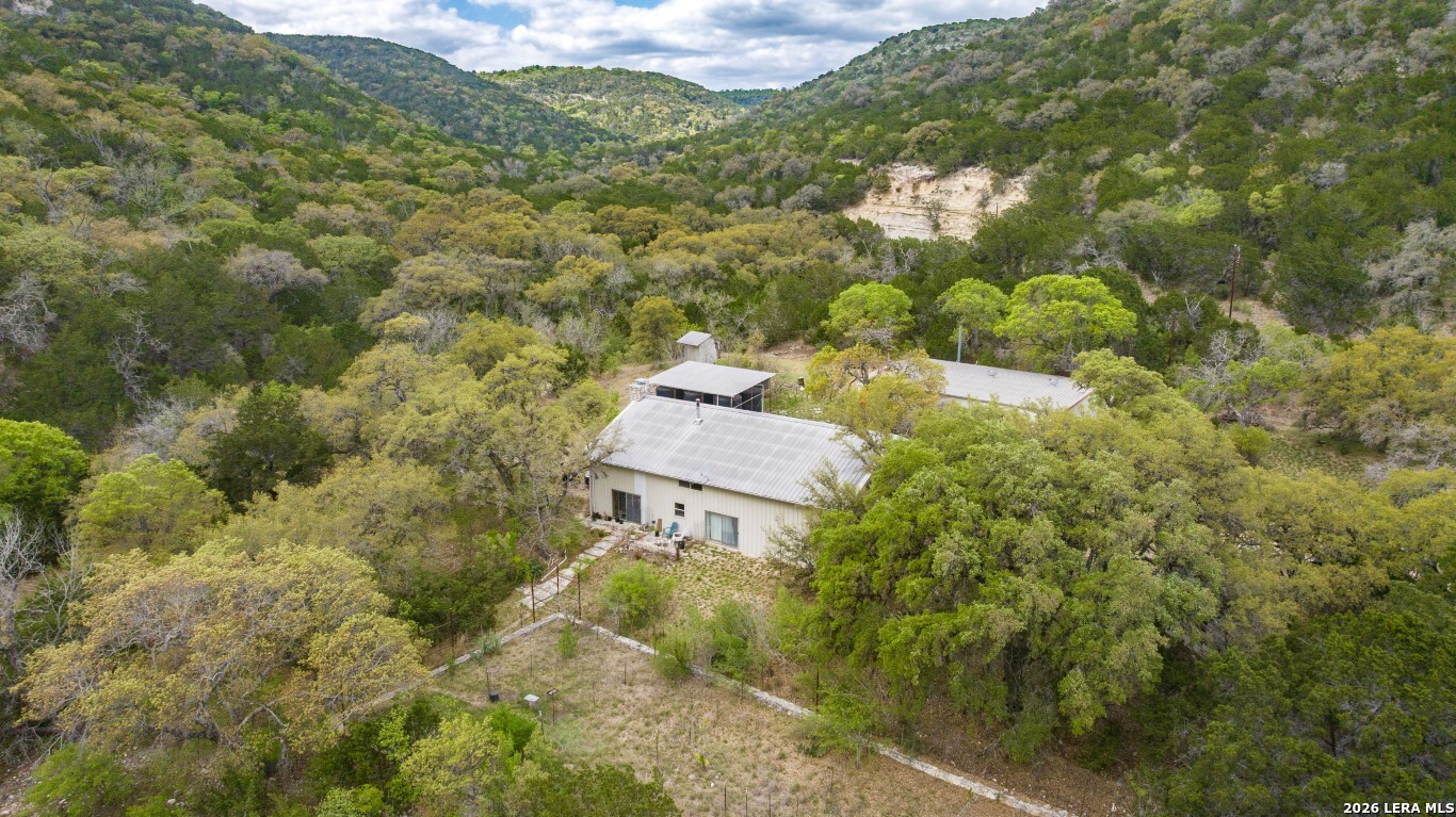 3655 North Seco Creek Road Medina, TX 78055 - Photo 3 of 45 a aerial view of a house with a yard and outdoor seating