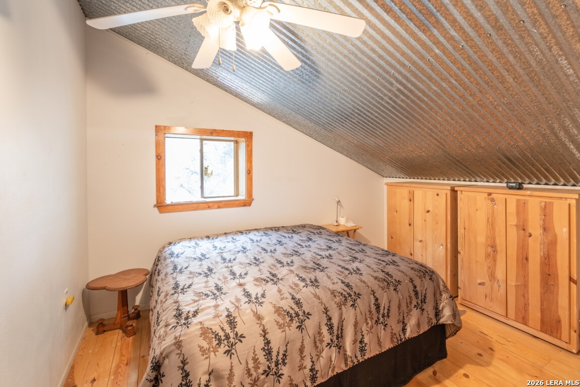 3655 North Seco Creek Road Medina, TX 78055 - Photo 38 of 45 a bedroom with a bed and a window