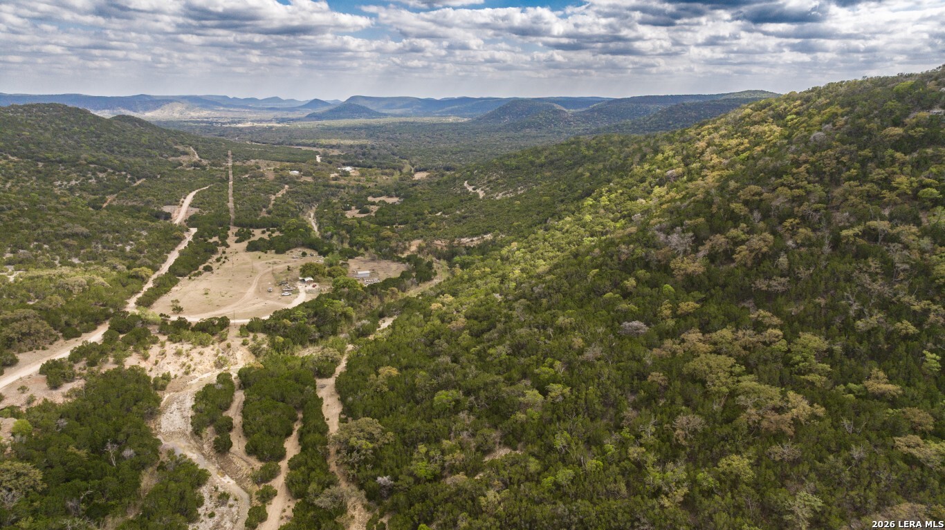 3655 North Seco Creek Road Medina, TX 78055 - Photo 4 of 45 a view of a field with mountains in the background