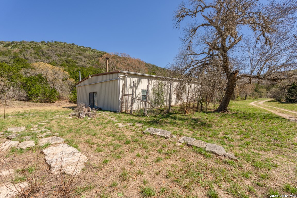 3655 North Seco Creek Road Medina, TX 78055 - Photo 5 of 45 a view of a house with a yard