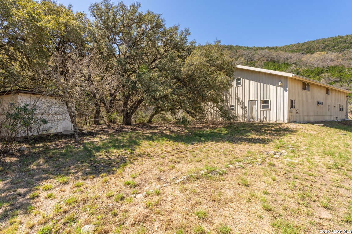 3655 North Seco Creek Road Medina, TX 78055 - Photo 9 of 45 a view of a house with a yard