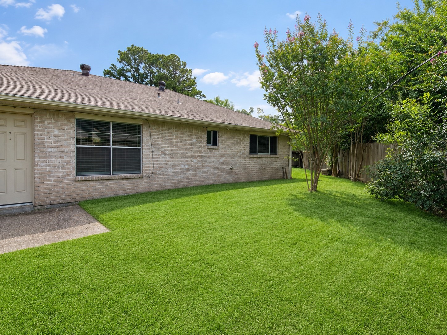 23019 Tree Bright Lane Spring, TX 77373 - Photo 20 of 20 Large green backyard with small patio area just outside the back door.
