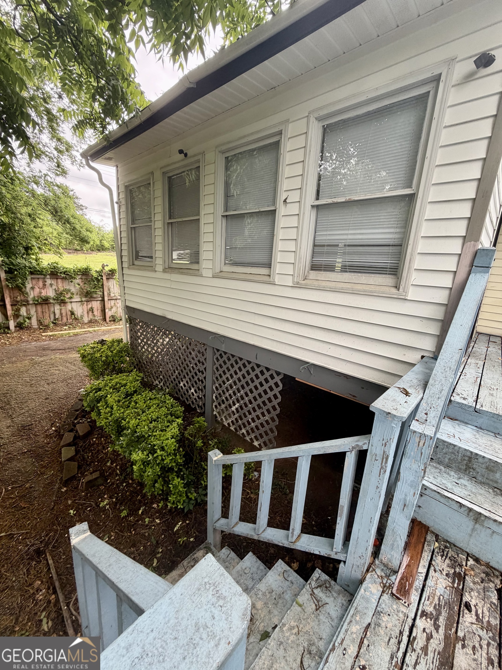 666 Woolfolk Street Macon, GA 31217 - Photo 55 of 60 a view of a balcony with wooden floor and fence