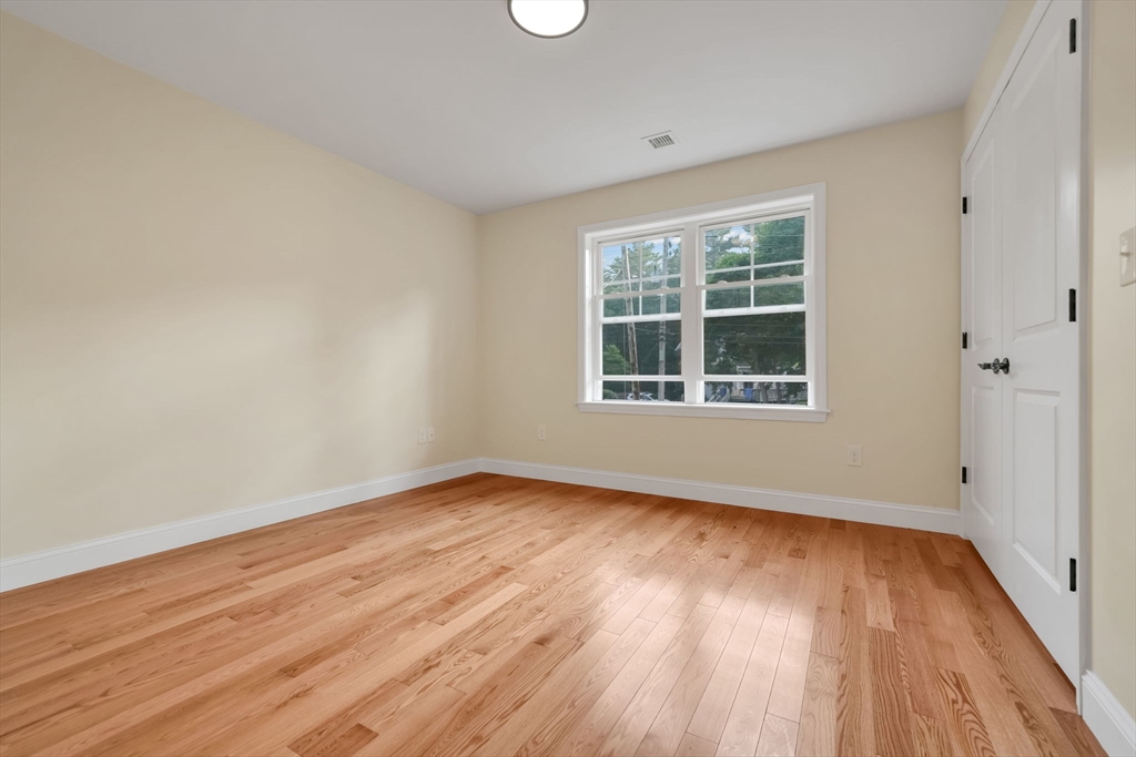 611 Delano Road Marion, MA 02738 - Photo 34 of 34 a view of an empty room with wooden floor and a window