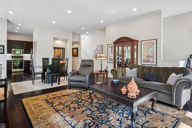 a living room with furniture a rug and a table