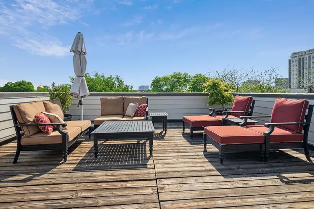 an outdoor sitting area with furniture and a garden