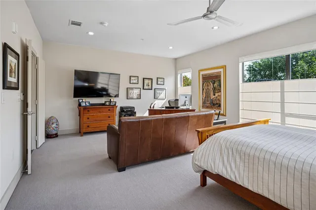 a bedroom with a bed window and a television