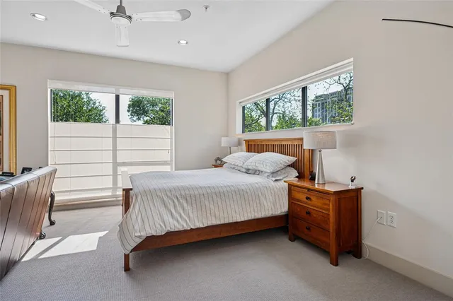 a bedroom with a bed chair and window