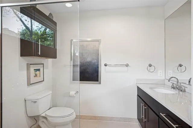 a bathroom with a toilet a sink and mirror