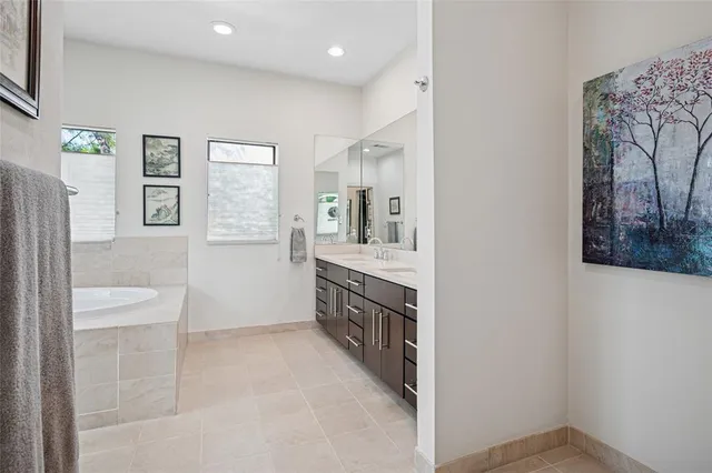 a spacious bathroom with a granite countertop sink a toilet and a shower
