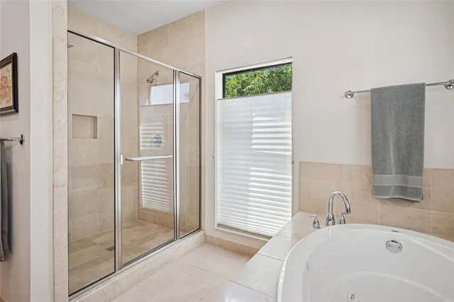 a bathroom with a bathtub and a shower