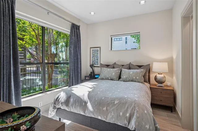 a bedroom with a bed and a large window