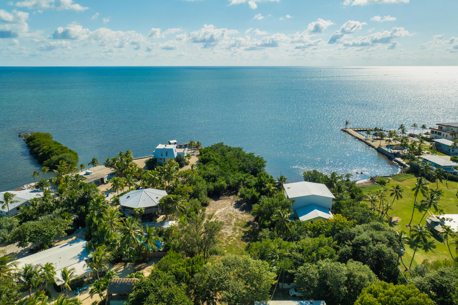 229 Coral Road Islamorada, FL 33036 - Photo 2 of 19 a view of a lake in middle of the green field