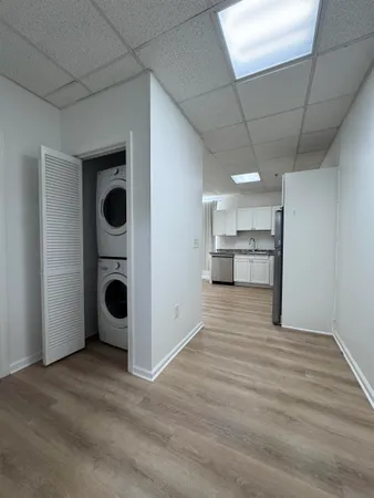 a view of a kitchen with a sink and cabinets