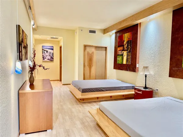 a bedroom with a bed and a flat screen tv
