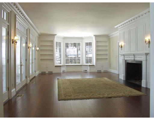 55 Sandy Pond Road Lincoln, MA 01773 - Photo 7 of 13 a view of an empty room with a fireplace and a window