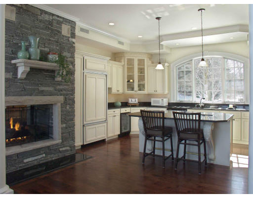 55 Sandy Pond Road Lincoln, MA 01773 - Photo 8 of 13 a open kitchen with granite countertop a stove dining table chairs and a fireplace