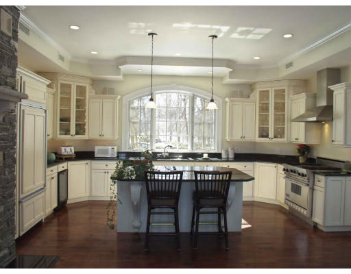 55 Sandy Pond Road Lincoln, MA 01773 - Photo 10 of 13 a kitchen with stainless steel appliances granite countertop a stove a sink dishwasher a refrigerator a dining table and chairs with wooden floor