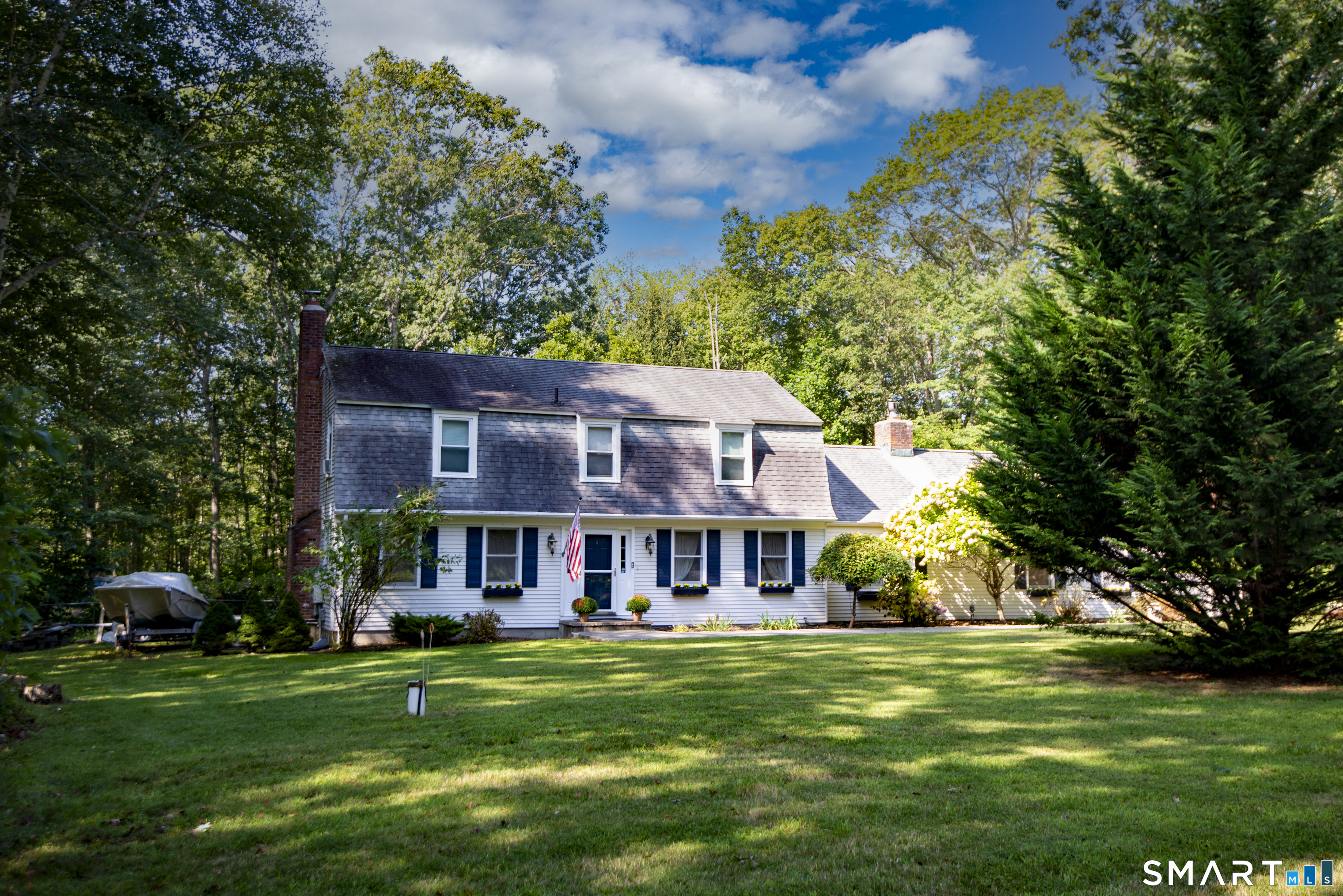 185 Ingham Hill Road Old Saybrook, CT 06475 - Photo 17 of 46 a view of a big house with a big yard and large trees