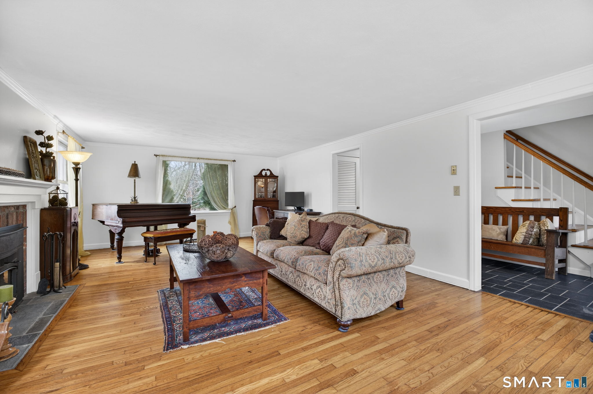 185 Ingham Hill Road Old Saybrook, CT 06475 - Photo 24 of 46 a living room with fireplace furniture and a wooden floor