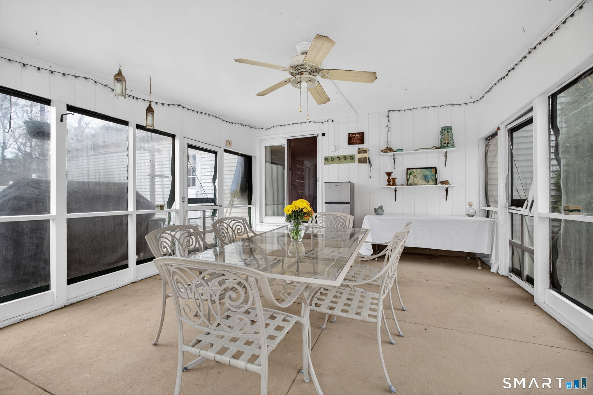 185 Ingham Hill Road Old Saybrook, CT 06475 - Photo 30 of 46 a living room with furniture a chandelier and a glass door