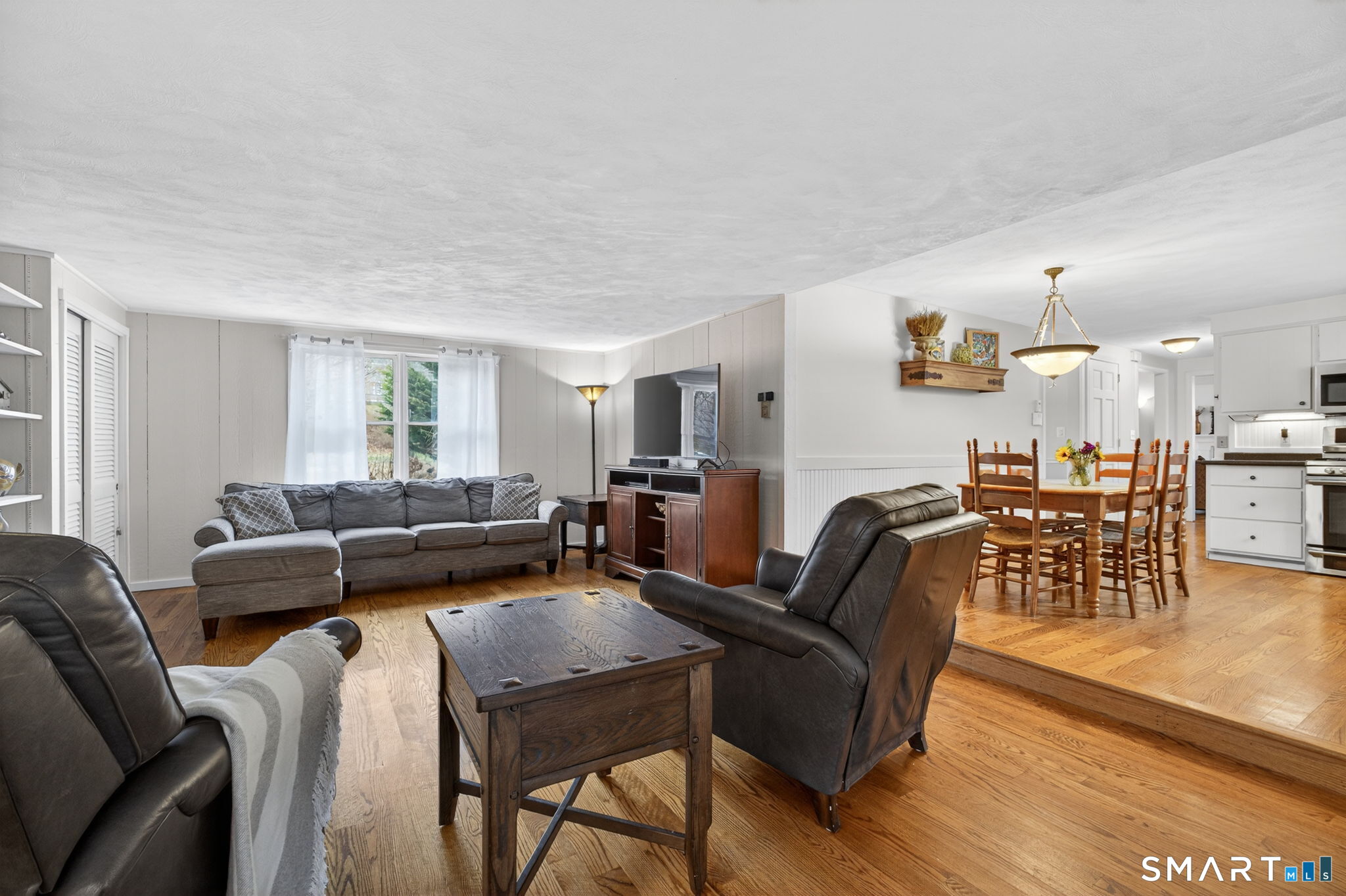185 Ingham Hill Road Old Saybrook, CT 06475 - Photo 32 of 46 a living room with furniture and a wooden floor