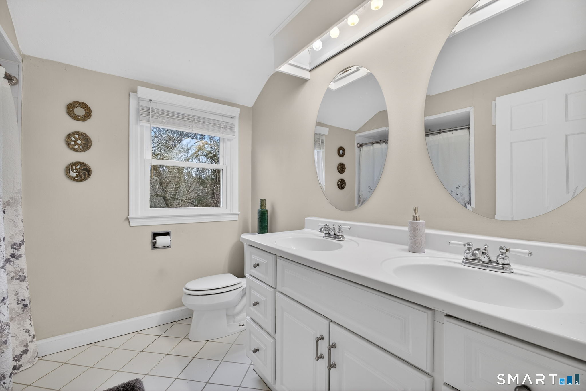 185 Ingham Hill Road Old Saybrook, CT 06475 - Photo 36 of 46 a bathroom with a double vanity sink mirror and toilet