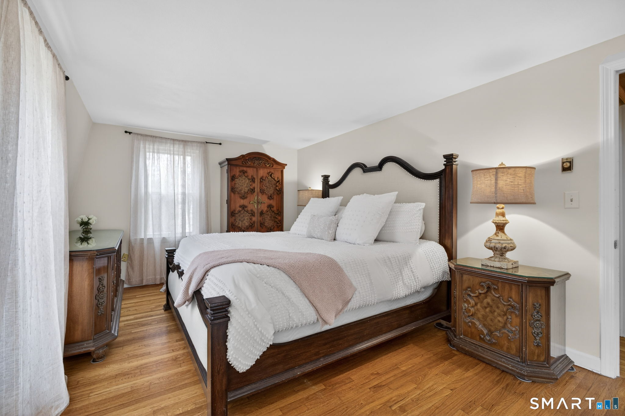 185 Ingham Hill Road Old Saybrook, CT 06475 - Photo 38 of 46 a bed sitting in a spacious bedroom next to a window and dresser