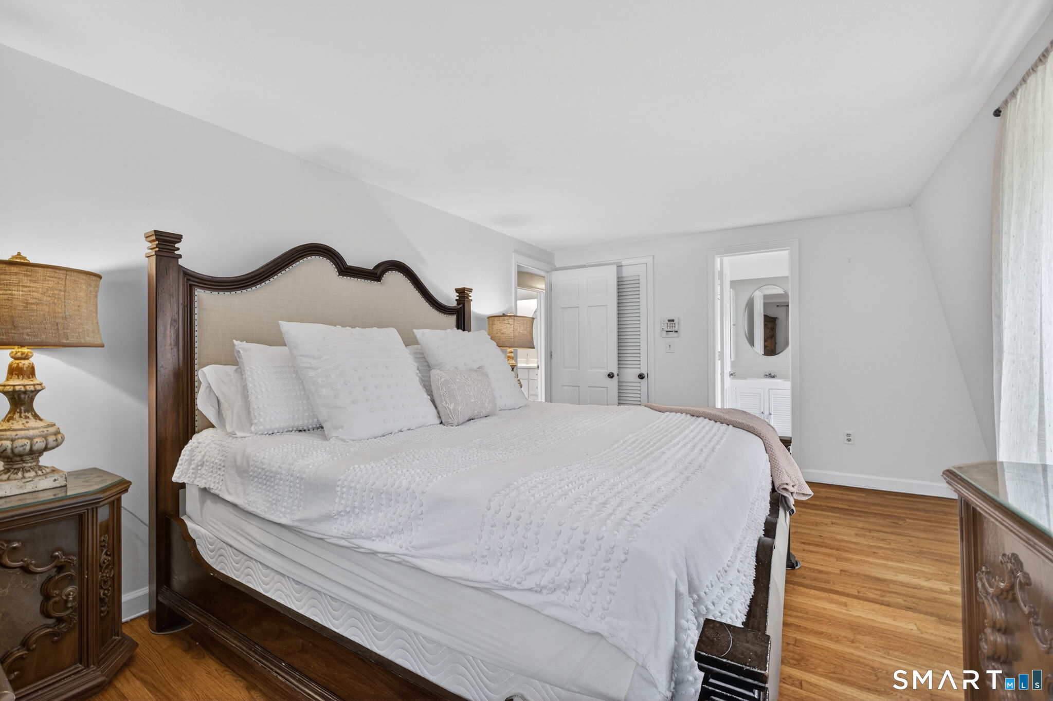 185 Ingham Hill Road Old Saybrook, CT 06475 - Photo 39 of 46 a bedroom with bed and a night stand