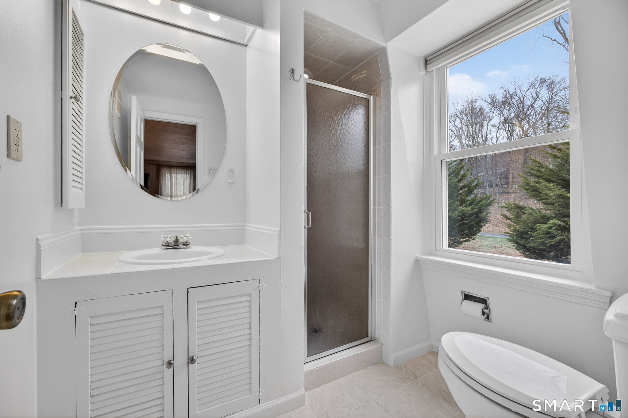 185 Ingham Hill Road Old Saybrook, CT 06475 - Photo 40 of 46 a bathroom with a toilet a sink and mirror
