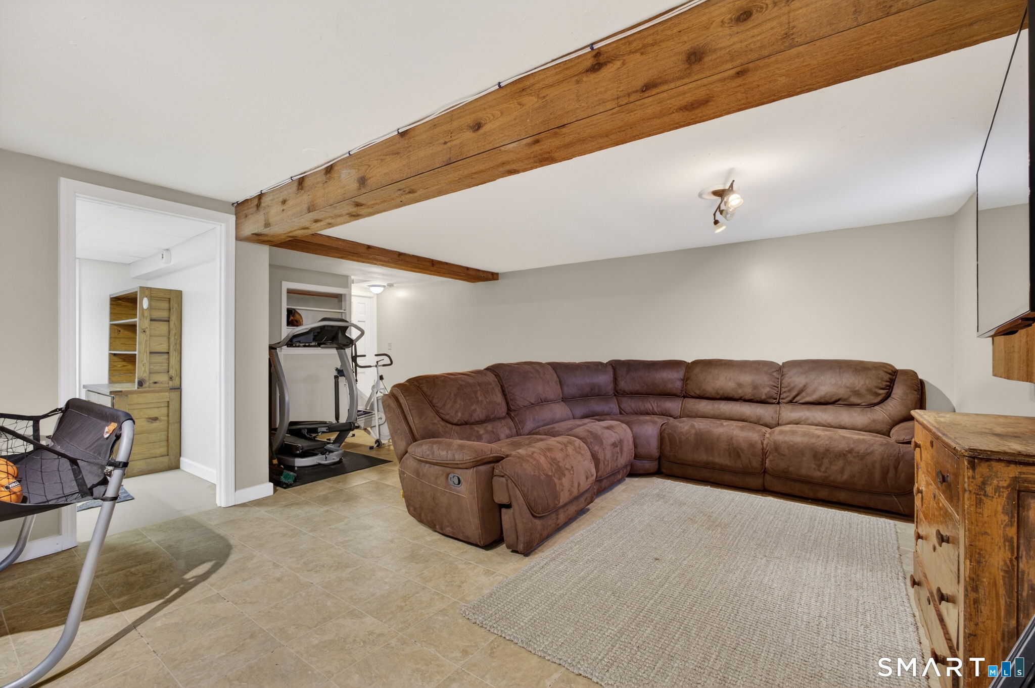 185 Ingham Hill Road Old Saybrook, CT 06475 - Photo 42 of 46 a living room with furniture a gym equipment and a large window