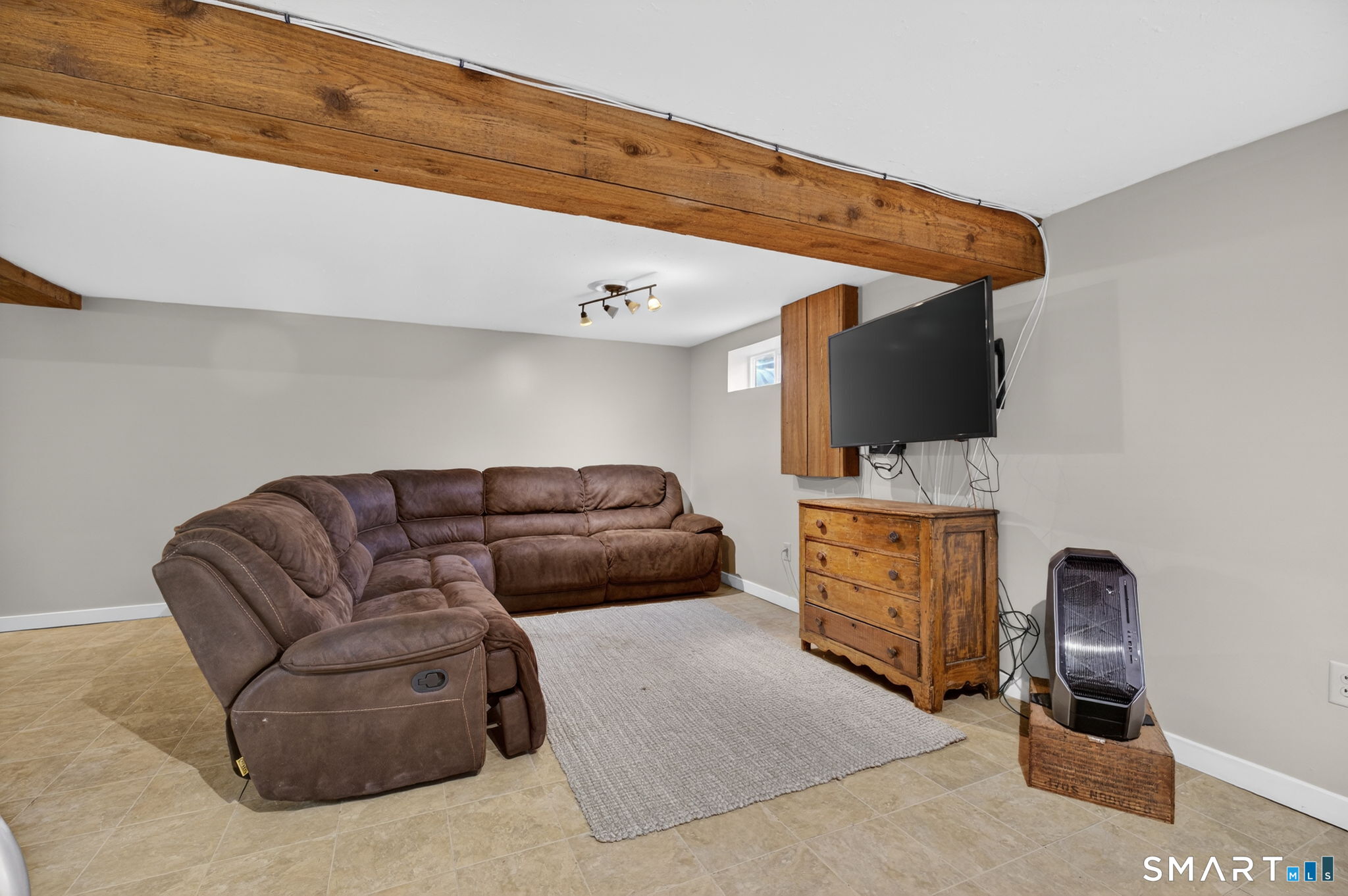 185 Ingham Hill Road Old Saybrook, CT 06475 - Photo 43 of 46 a living room with furniture and a flat screen tv