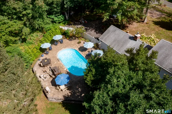 an aerial view of a house with a swimming pool yard and outdoor seating