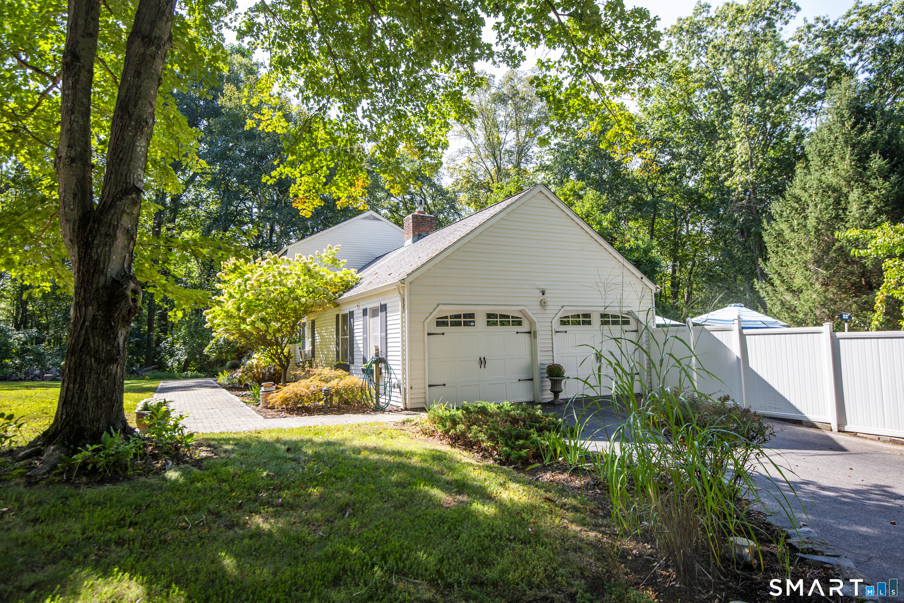 185 Ingham Hill Road Old Saybrook, CT 06475 - Photo 10 of 46 a view of a house with a yard plants and large tree