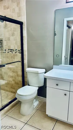 a white toilet sitting next to a bathroom sink