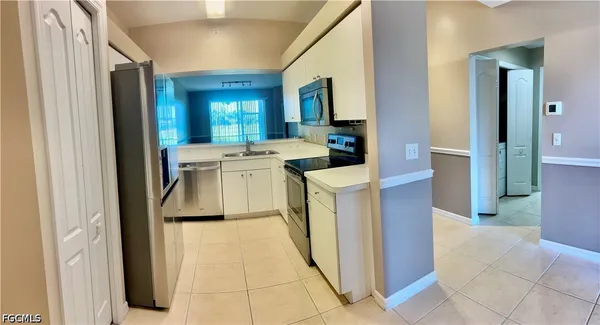 a utility room with sink dryer and washer