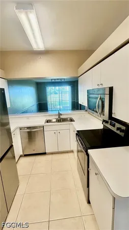 a kitchen with a stove a sink and a refrigerator