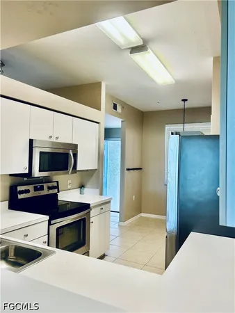 a kitchen with stainless steel appliances a stove a refrigerator and a sink