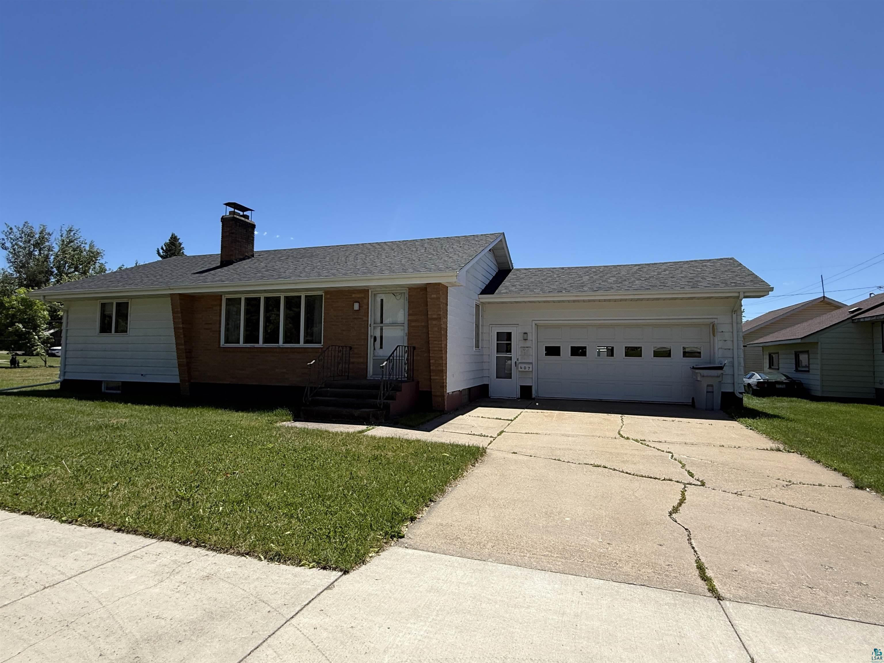 607 3rd Street Northeast Chisholm, MN 55719 - Photo 2 of 32 Single-story residence featuring a brick and white siding exterior