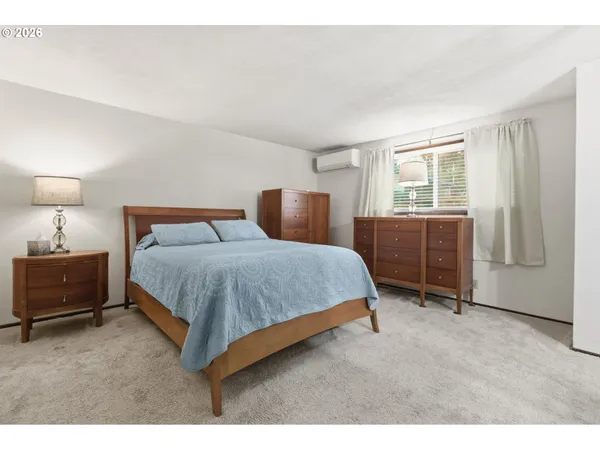 a bedroom with a bed and dresser