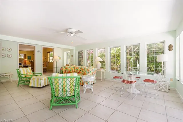 a living room with furniture and large windows