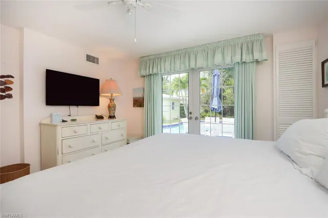 a bedroom with a large bed and a flat screen tv