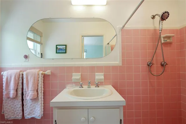 a bathroom with a sink a toilet and mirror