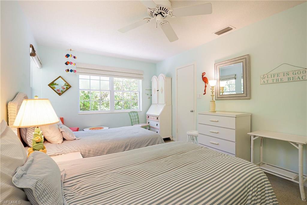 361 1st Avenue North Naples, FL 34102 - Photo 25 of 28 a bedroom with a bed and a window