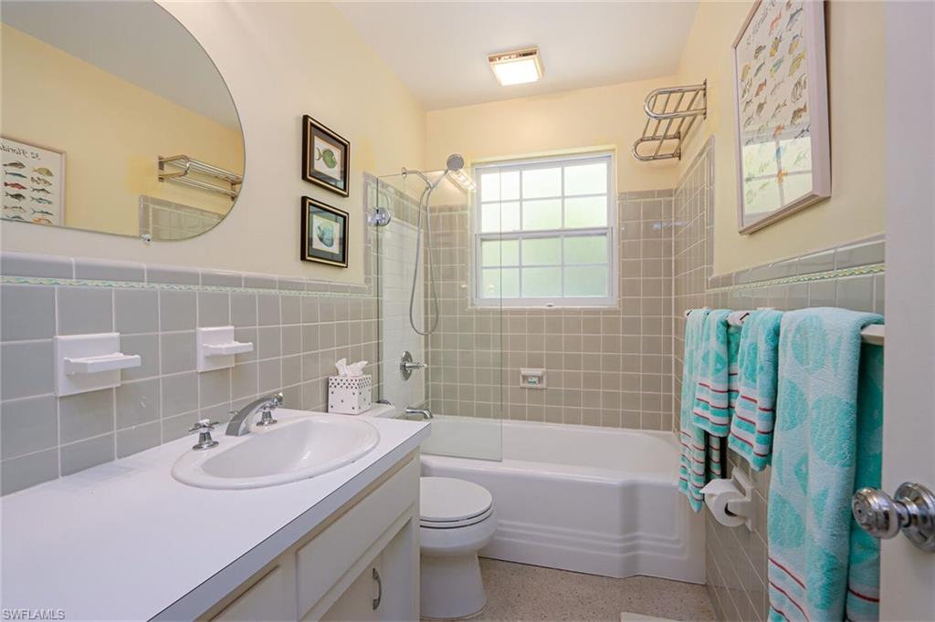 361 1st Avenue North Naples, FL 34102 - Photo 26 of 28 a bathroom with a sink a toilet and shower